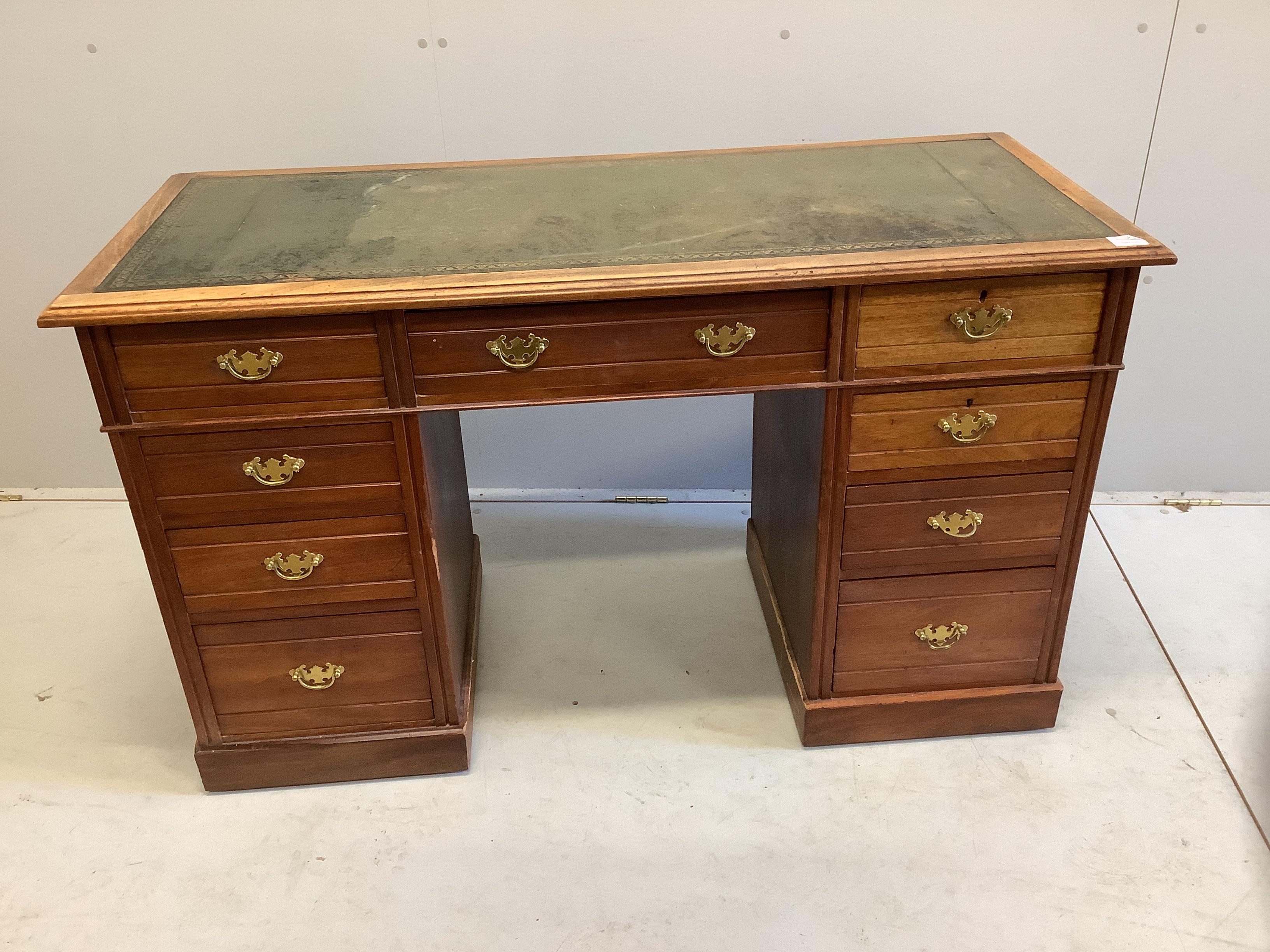 A late Victorian mahogany kneehole writing table, fitted nine small drawers, width 130cm, depth 55cm, height 78cm